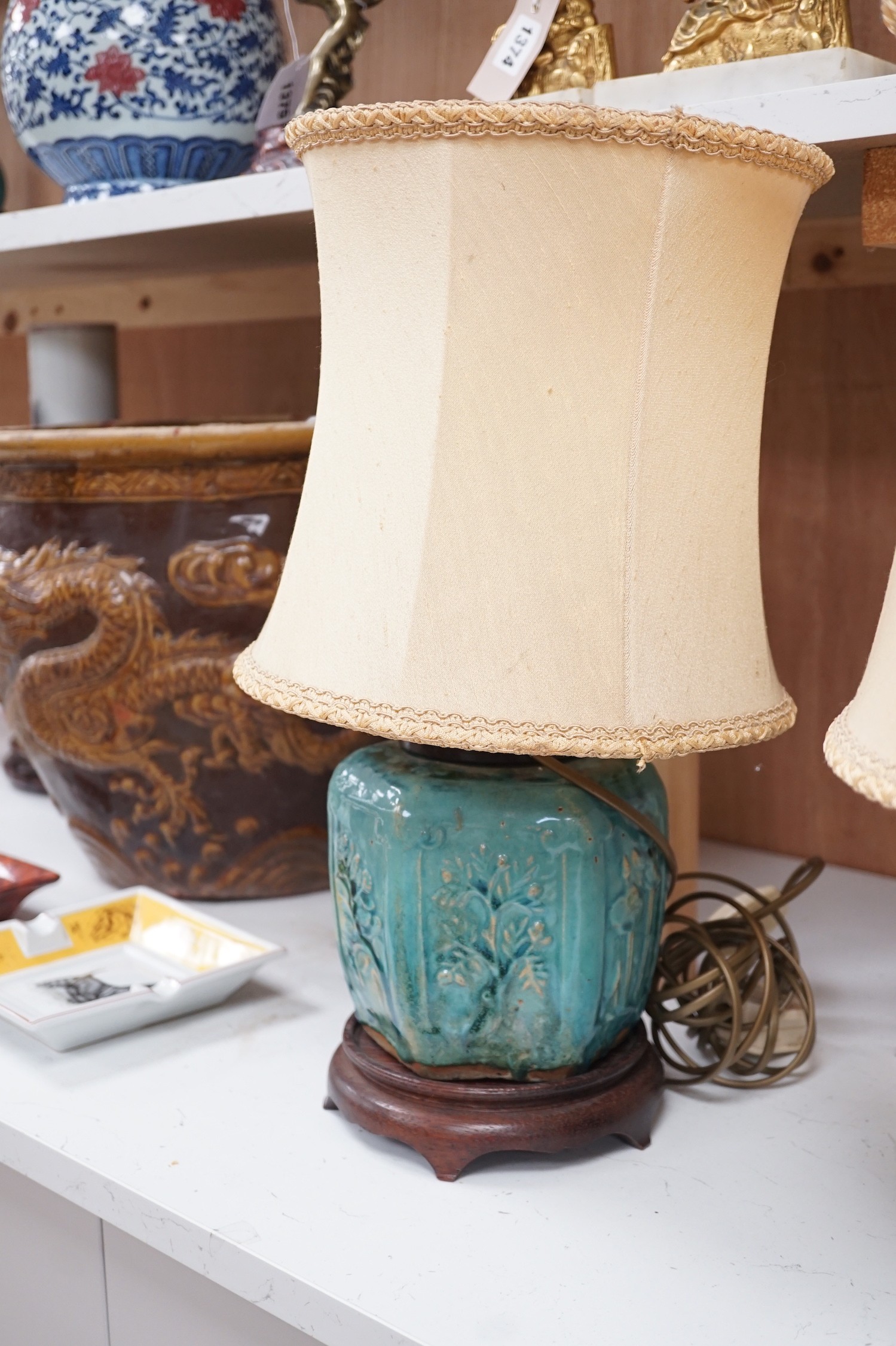 A pair of Chinese blue glazed earthenware hexagonal vase lamps on wooden mounts, with their shades. 45cm tall overall